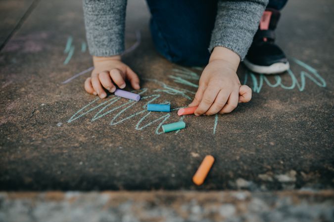 Child playing with colorful chalk