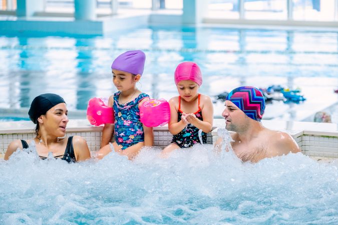 Family relaxing in bubbling pool