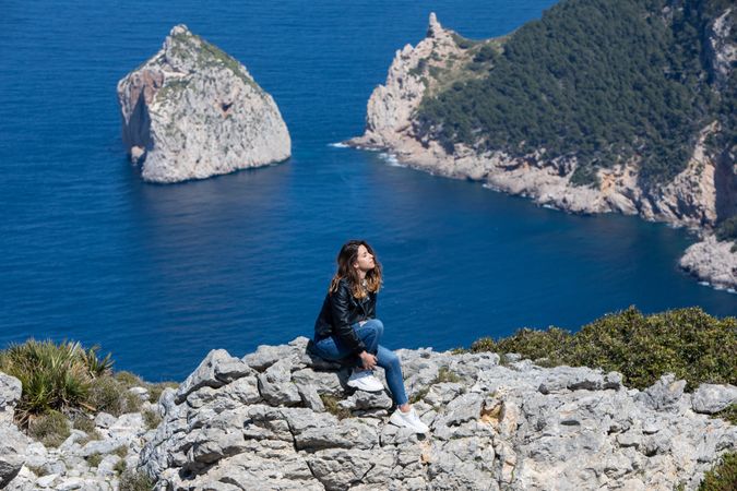 Young woman resting on cliff