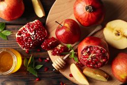 Top view of apples and pomegranate with honey