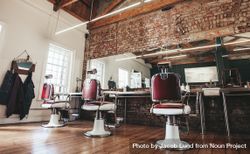 Horizontal shot of empty chairs in retro styled barbershop 5R19D0