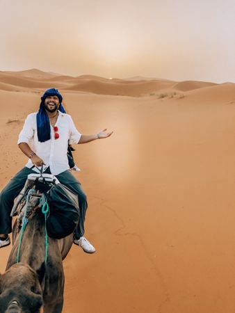Man riding a camel in Errachidia, Morocco