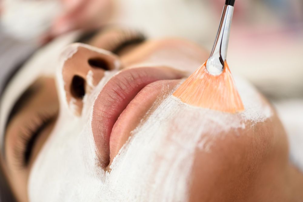 Woman receiving facemask in spa