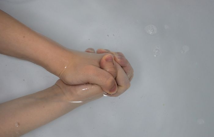 Hands clasped in water