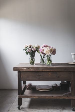 Bunches of flowers in vases on table