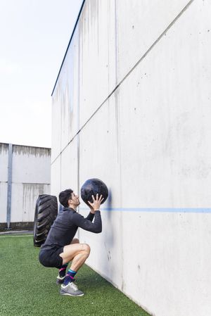 Man training with ball near wall