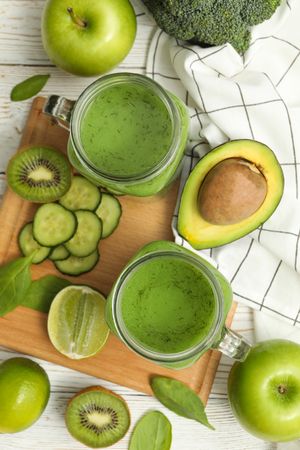 Concept of healthy food with smoothie, vegetables and fruits on wooden table