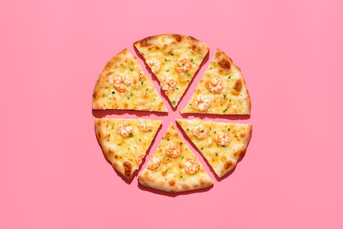Slice pizza with shrimp, above view on a pink background