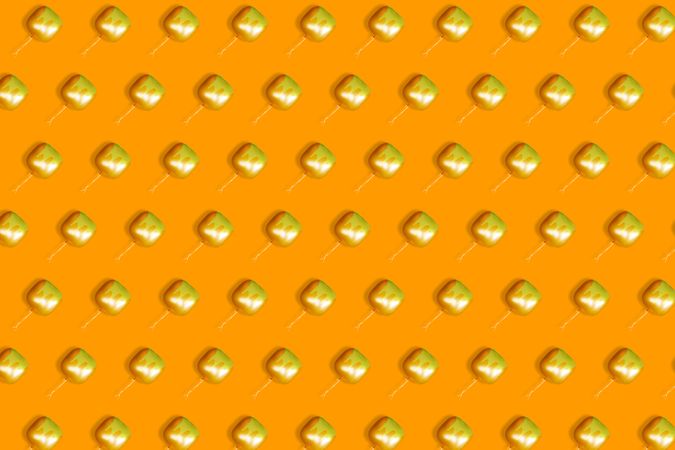 Pattern of floating orange square  balloons with dripping paint on orange background