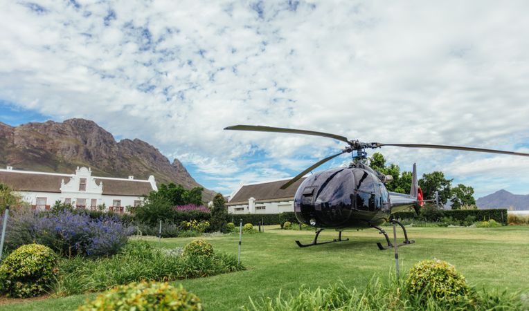 Private helicopter on the lawn of a luxury villa