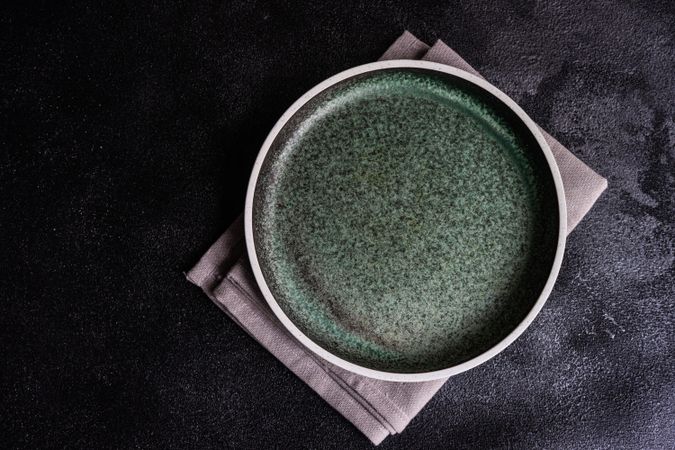 Empty grey plate with napkin as a table setting concept