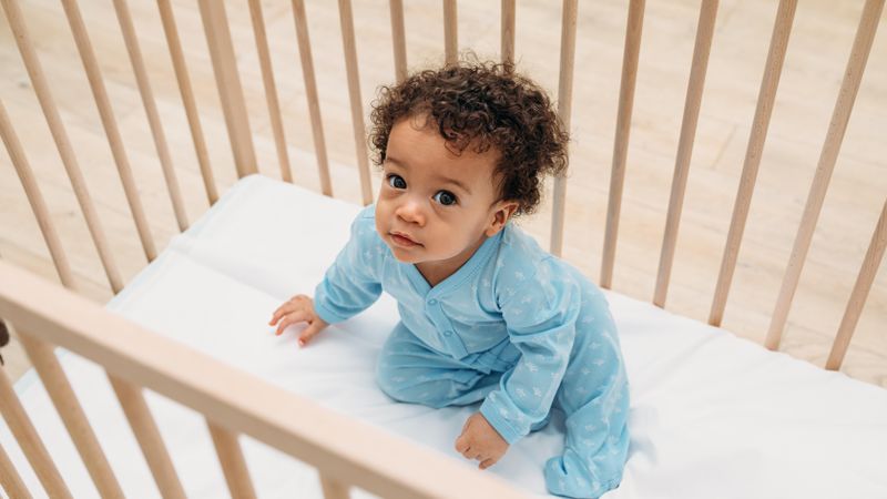 Curious baby boy looking up in his crib