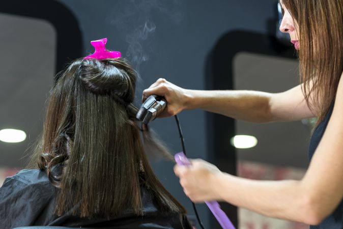 Brunette woman having hair styles in hair salong