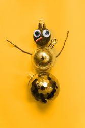 Gold snowman made out of Christmas decorations