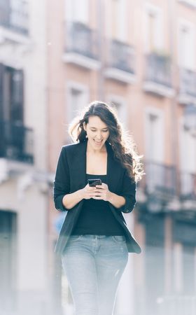 Young female walking with smartphone