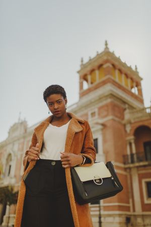 Stylish Black woman with handbag on street