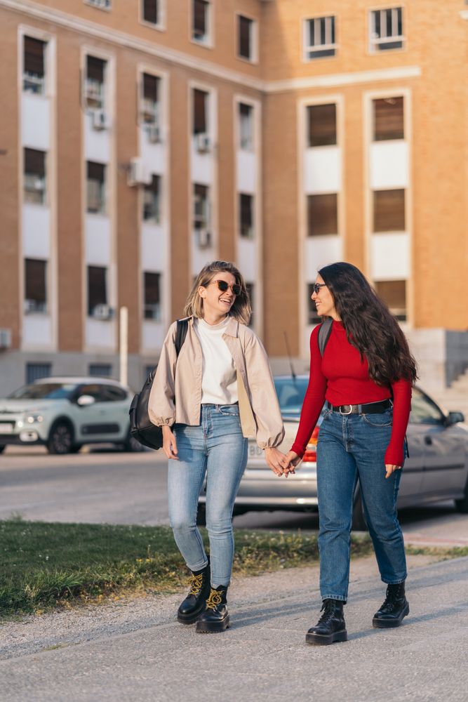 student couple in college holding hands