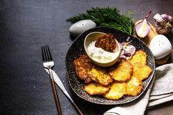 Top view of traditional Ukrainian dish deruny with dipping sauce and dill