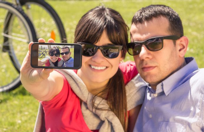 Couple in love taking a selfie photo on the park