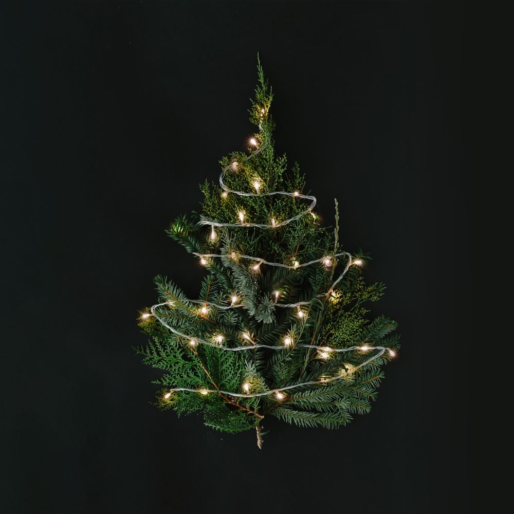 Christmas tree with lights on dark table top