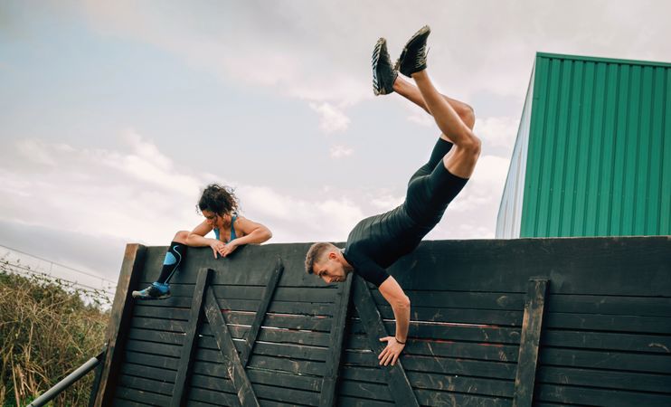 Participants in obstacle course climbing wall