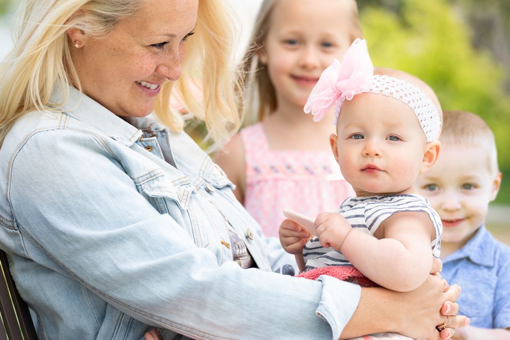 Mother and Children At The Park
