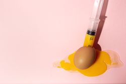Syringe sucking yolk out of raw egg