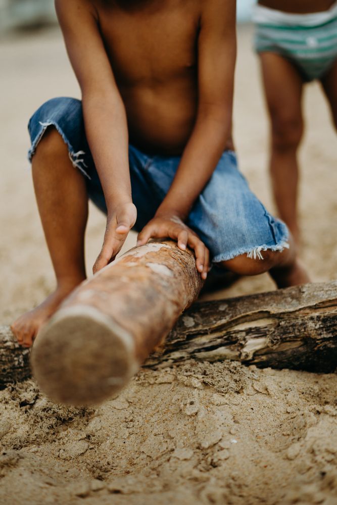 Crop Black boy playing on beach