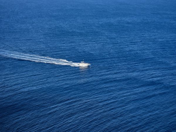 White yacht sailing in blue sea