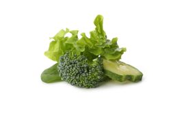 Salad, cucumber, broccoli and spinach isolated on blank background