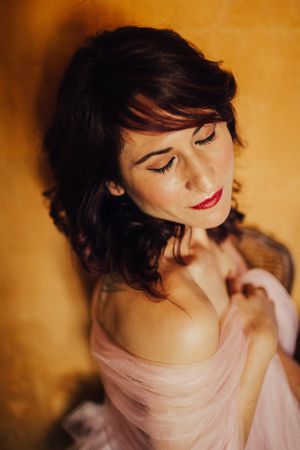 Sensual woman covered in pink veil