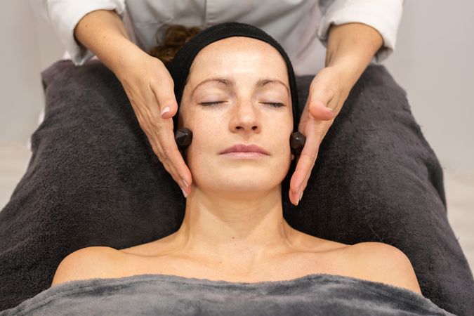 Woman receiving facial in salon