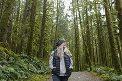 Happy older woman walking on a trail