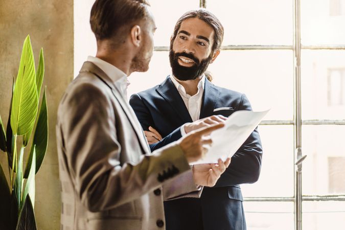 Business colleagues talking while standing in the office