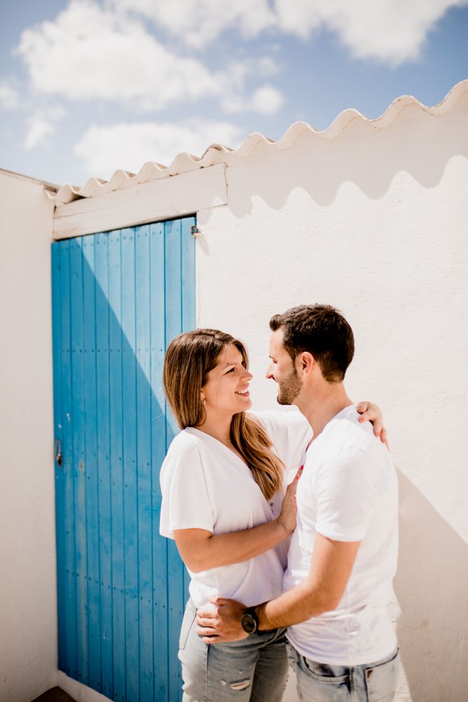 Loving couple cuddling near beach house