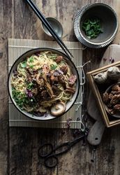 Miso noodles with egg plants and shiitake in bowl on table