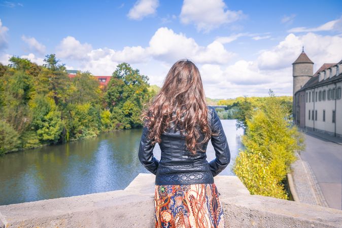 Woman looking toward the river and cloudscape