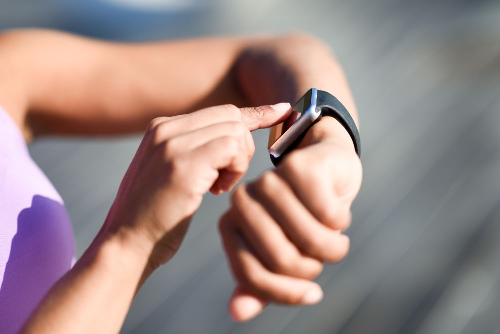 Close-up of hands and wrist with smart watch screen
