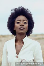 Portrait of woman with afro hair under blue sky 5zpzmb