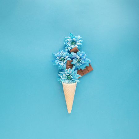 Blue flowers and chocolates emerging from cone