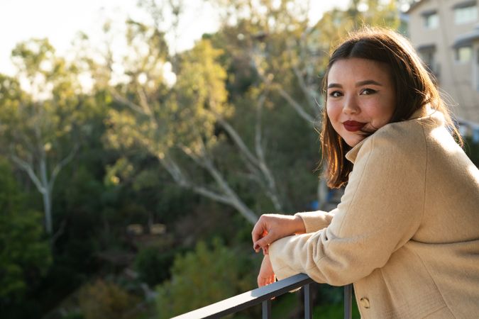 Pretty young Asian woman looking at camera over her shoulder