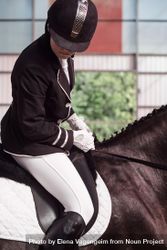 Horseback rider in uniform practicing dressage 0yZZj5