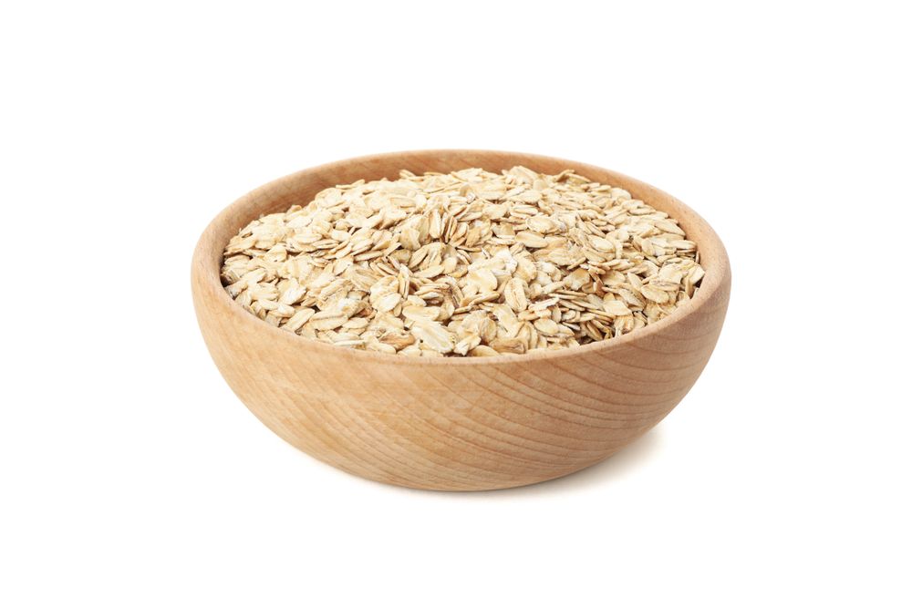 Bowl with oatmeal flakes isolated on plain background