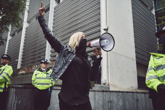 London, England, United Kingdom - June 6th, 2020: Woman holding loudspeaker among police
