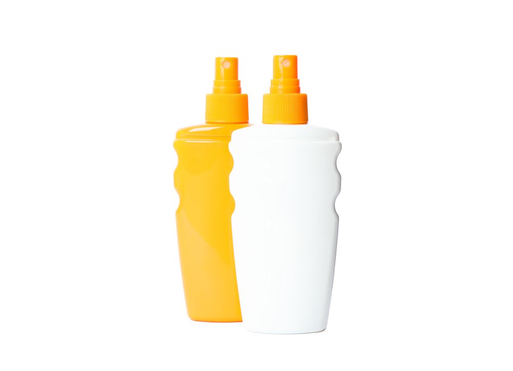 Sunscreen sprays isolated on plain background. Summer vacation accessories