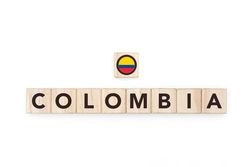 Wooden blocks bearing the name and flag of Colombia. Colombian and South American Culture, national identity, travel, and geography in a copy space design.