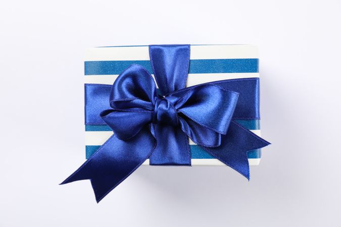 Beautiful gift box with bow on blank background, space for text