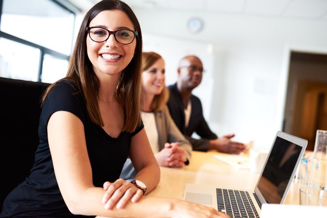 Happy businessman in a meeting with her laptop