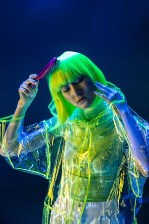Asian woman brushing yellow hair