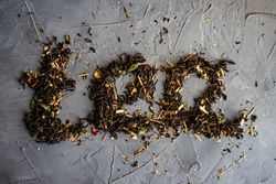 Floral tea on counter spelling "tea"